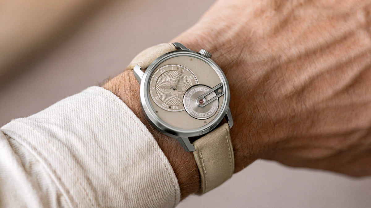 Armin Strom Tribute 1 Sandstein worn on the wrist, sand dial and nubuck strap, close view