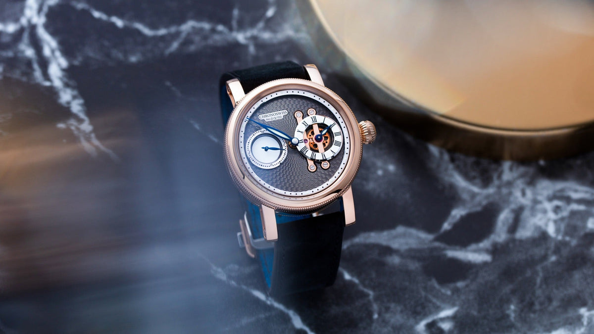 Chronoswiss Strike Two Nugget resting on dark marble, anthracite guilloché dial in close view