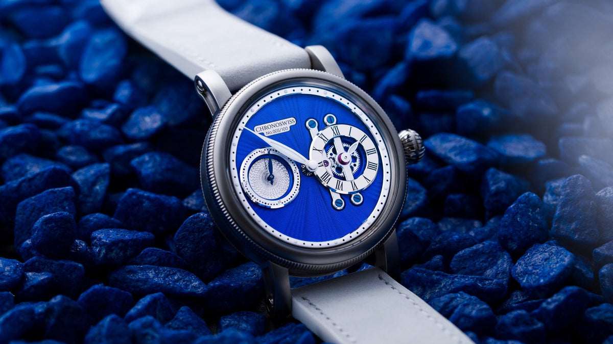 Chronoswiss Strike Two Stellar Blue resting on blue stones, dial in close view
