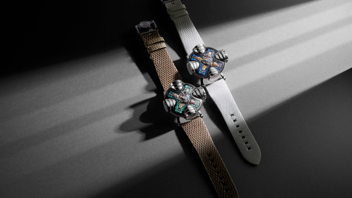 MB&F HM11 Art Deco, Blue and Green editions together, light streaks across a grey surface