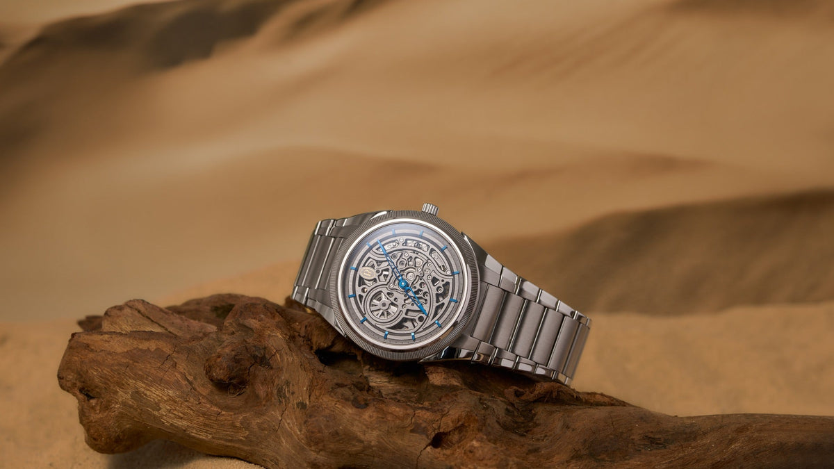 Parmigiani Fleurier Tonda PF Skeleton x PRJKT8 resting on driftwood in the desert, three-quarter view
