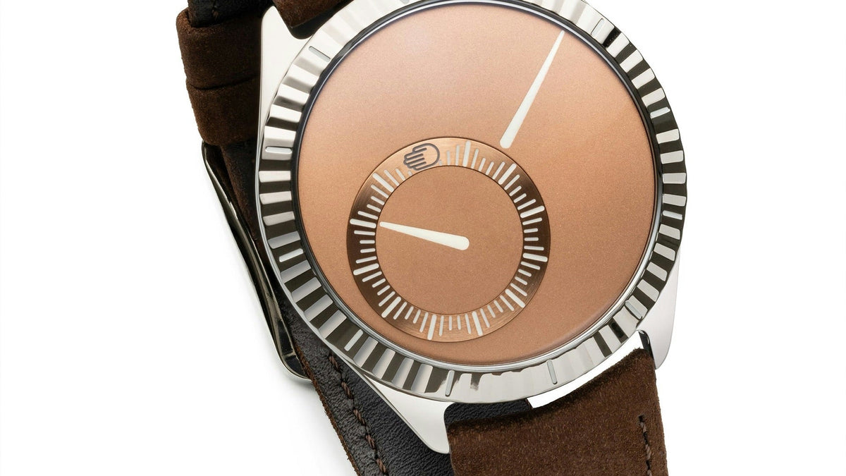 Ressence TYPE 9 ARM ‘Scattering Sun’ with salmon dial, fluted titanium bezel and chocolate suede strap, angled view