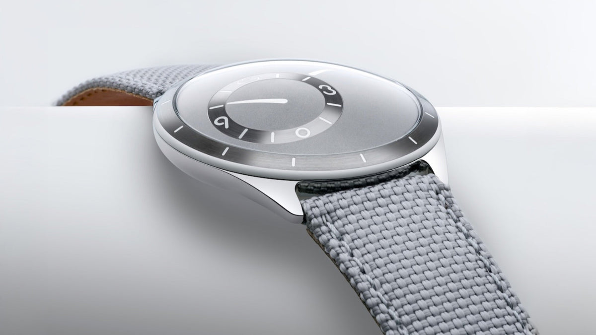 Ressence TYPE 9 Grey resting on a pale surface, profile view