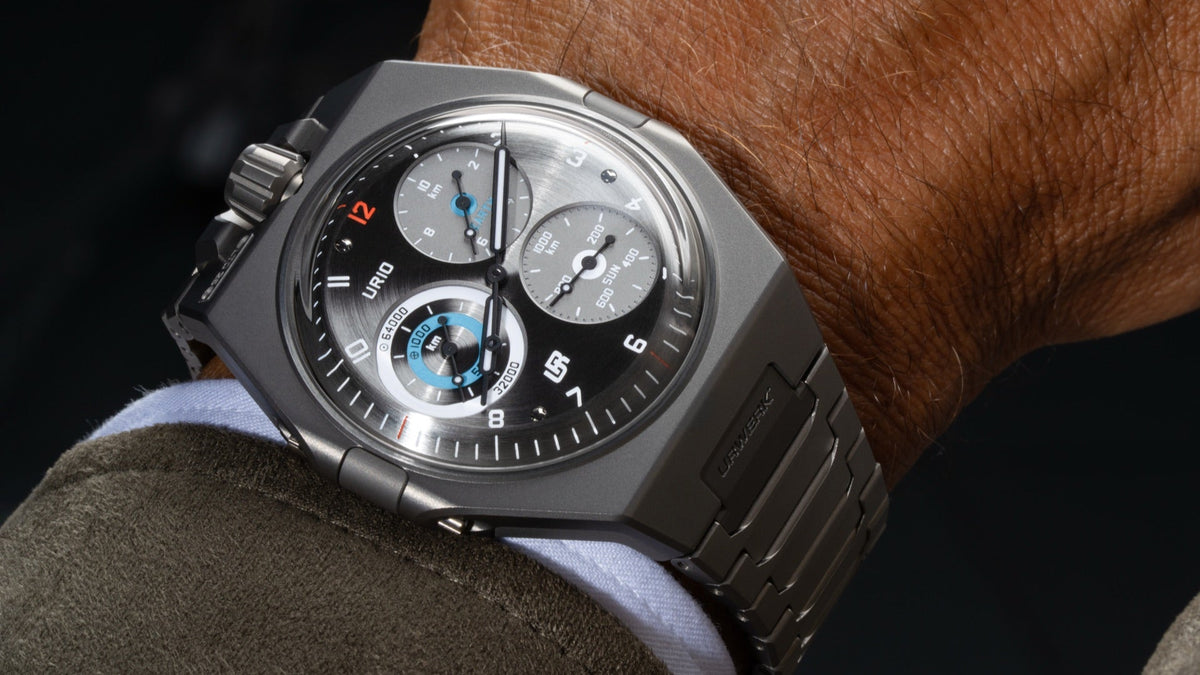 URWERK UR-10 SpaceMeter worn on the wrist under a jacket cuff, dial showing the distance counters