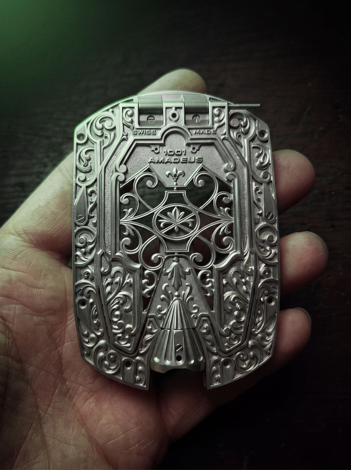 URWERK UR-1001 Amadeus, its engraved titanium caseback held in the hand