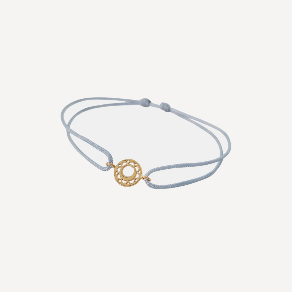 Tiny Om Communication disc bracelet on thread